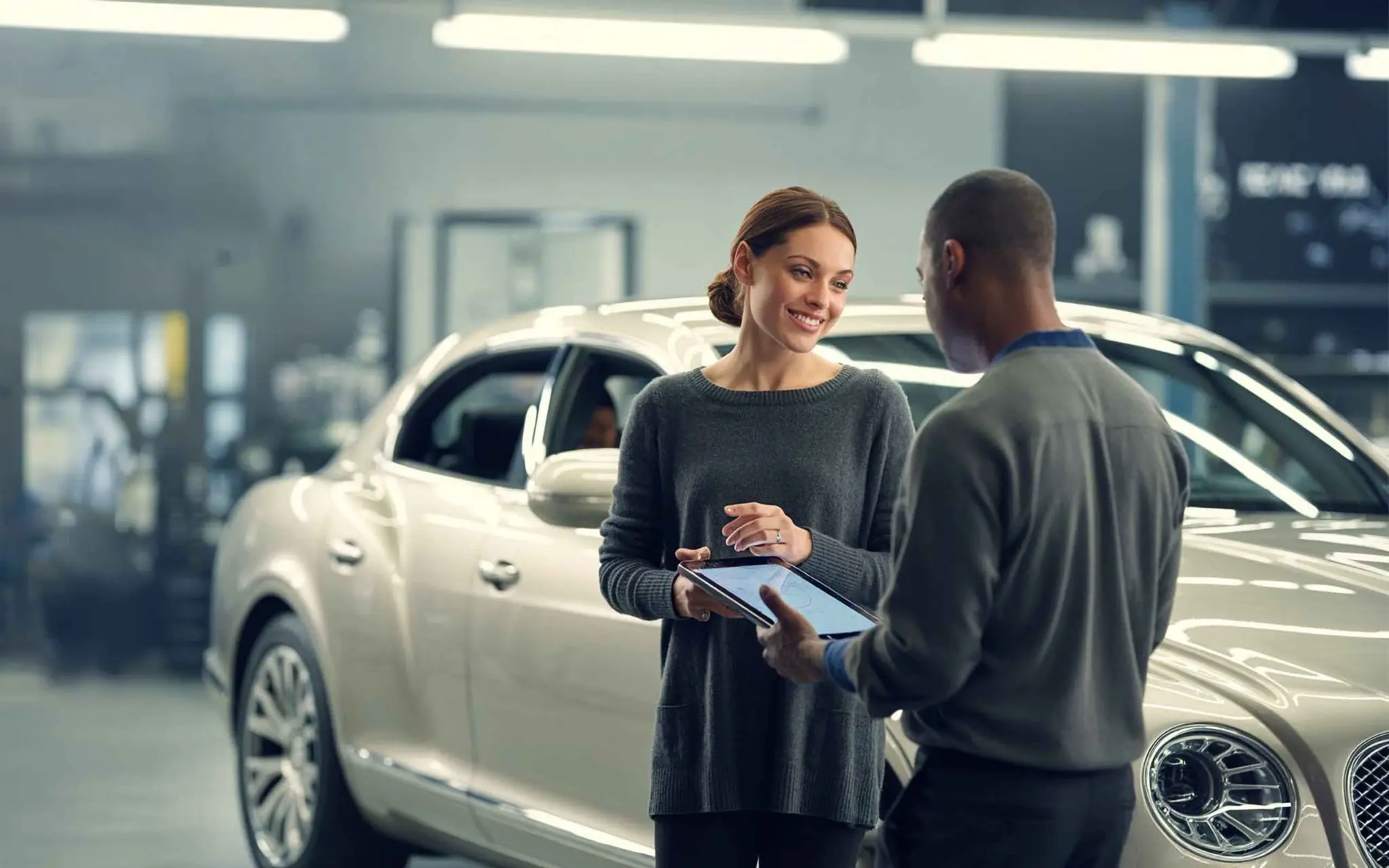 Service advisor consulting with customer at collision center