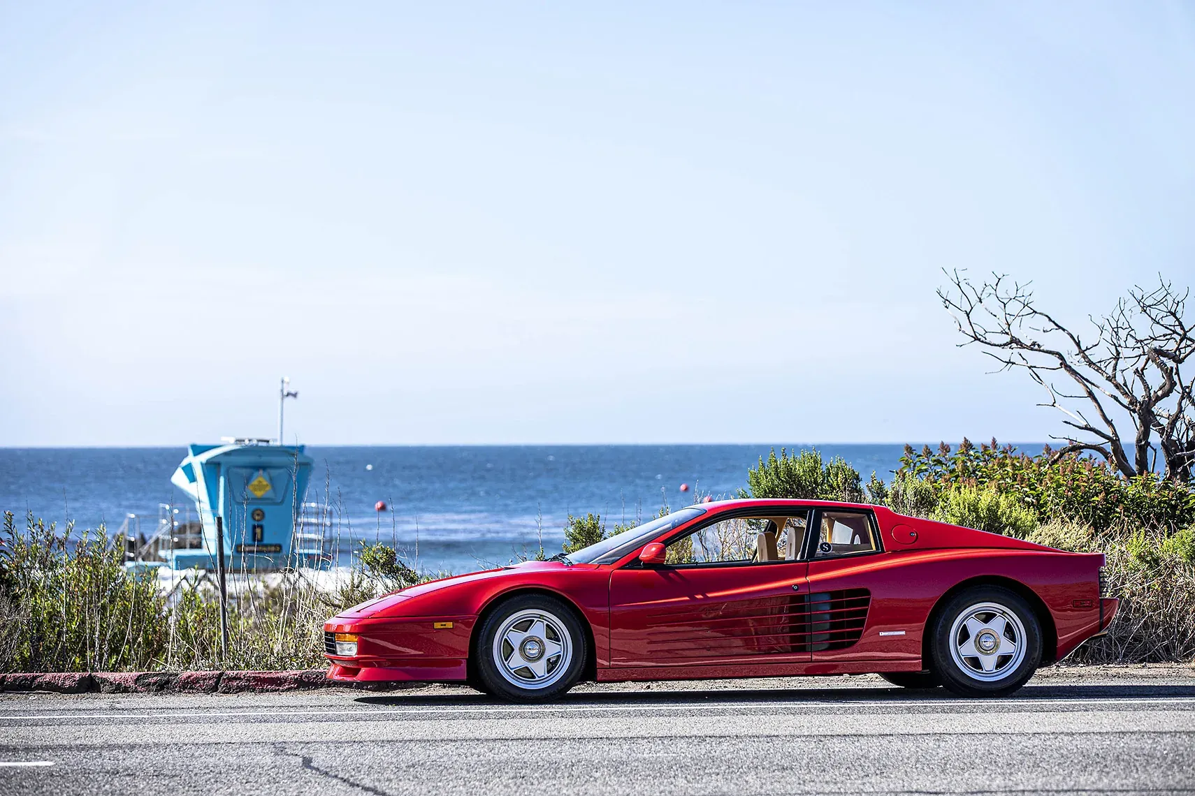 Ferrari Testarossa at the beach — The Stable classic car experience